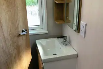 Glamping pod bathroom with a shower, sink and toilet (bring or hire towels)