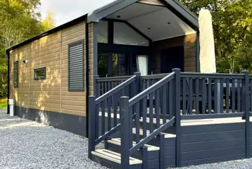Ensuite glamping cabins with step access and private decks with seating
