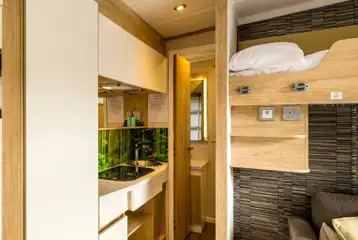 Glamping pod kitchen with a gas hob, kettle, toaster, fridge and microwave oven