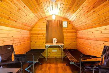 Camping pod interior with two single camp beds (bring own bedding)