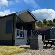 Ensuite glamping cabins with covered outdoor deck areas and brick BBQs