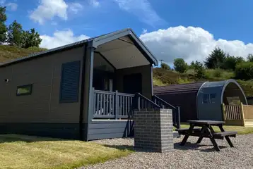 Ensuite glamping cabins with covered outdoor deck areas and brick BBQs