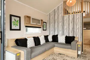 Glamping cabin interior with a large L-shaped sofa bed