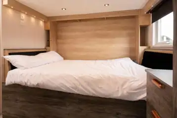 Glamping cabin dining area with a pull-down double bed