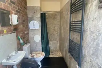 Toilets and showers interior with sink, mirror and heated towel rail Toilets and showers interior with sink, mirror and heated towel rail