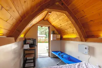 Oak Pods interior with camp bed, oven and grill Oak Pods interior with camp bed, oven and grill