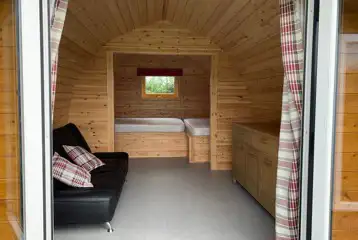 Camping pod interior with a small double bed and single bed Camping pod interior with a small double bed and single bed