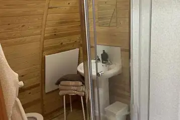 Cosy ensuite with a toilet, shower, and handwashing sink