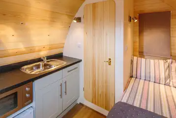 Ensuite glamping pod kitchenette with a microwave and sink