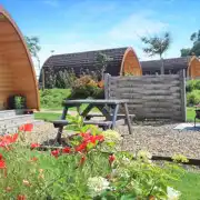 Ensuite glamping pod exterior with a picnic bench and fire pit Ensuite glamping pod exterior with a picnic bench and fire pit