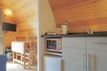Ensuite glamping pod kitchenette with a microwave, kettle and mini fridge