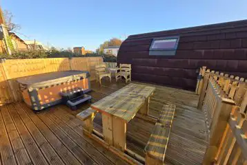 Alpaca pod gated garden with an electric hot tub and picnic bench