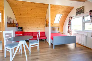 Owl pod with a double bed, sofa and dining area (bring bedding)