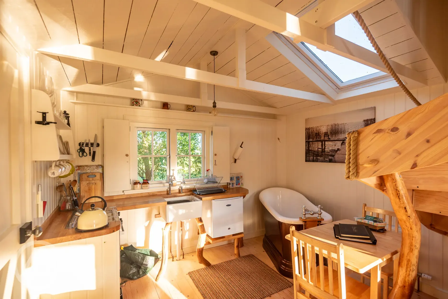 Wee Tree Howf Treehouse interior with a kitchen and slipper bath Wee Tree Howf Treehouse interior with a kitchen and slipper bath