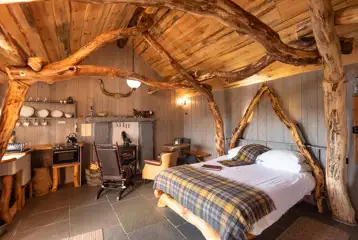 Whisky Howf Cabin interior with a wood burning stove Whisky Howf Cabin interior with a wood burning stove