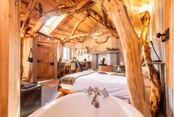 Whisky Howf Cabin interior with a king size bed and slipper bath Whisky Howf Cabin interior with a king size bed and slipper bath