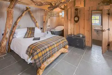 Whisky Howf Cabin interior with a king size bed and slipper bath Whisky Howf Cabin interior with a king size bed and slipper bath