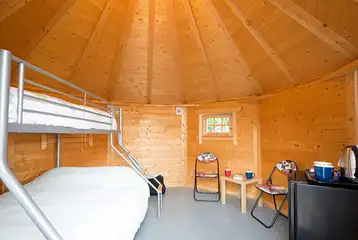 Camping cabin with a triple bunk bed and fold-away single camp bed Camping cabin with a triple bunk bed and fold-away single camp bed