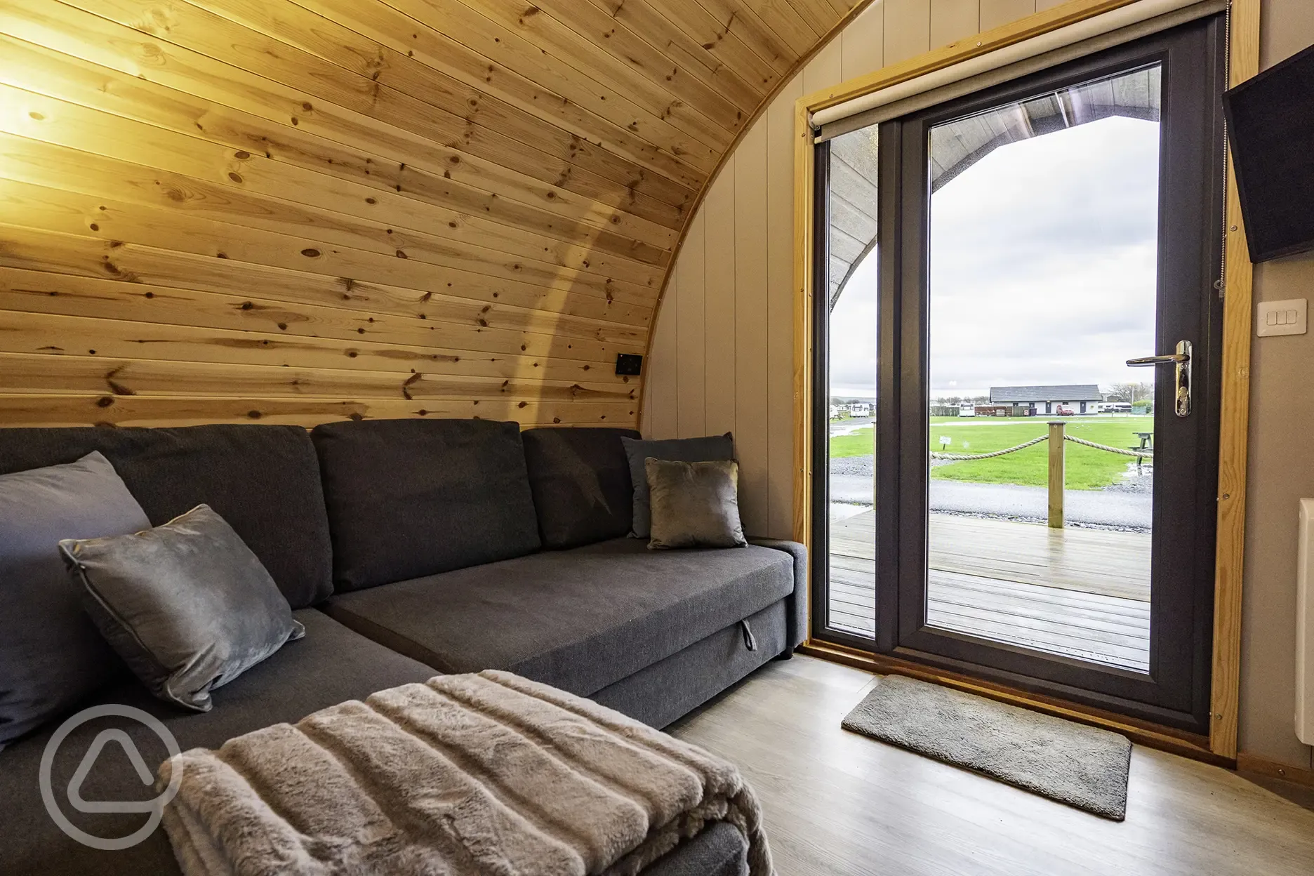 Mega glamping pod interior with a double sofa bed