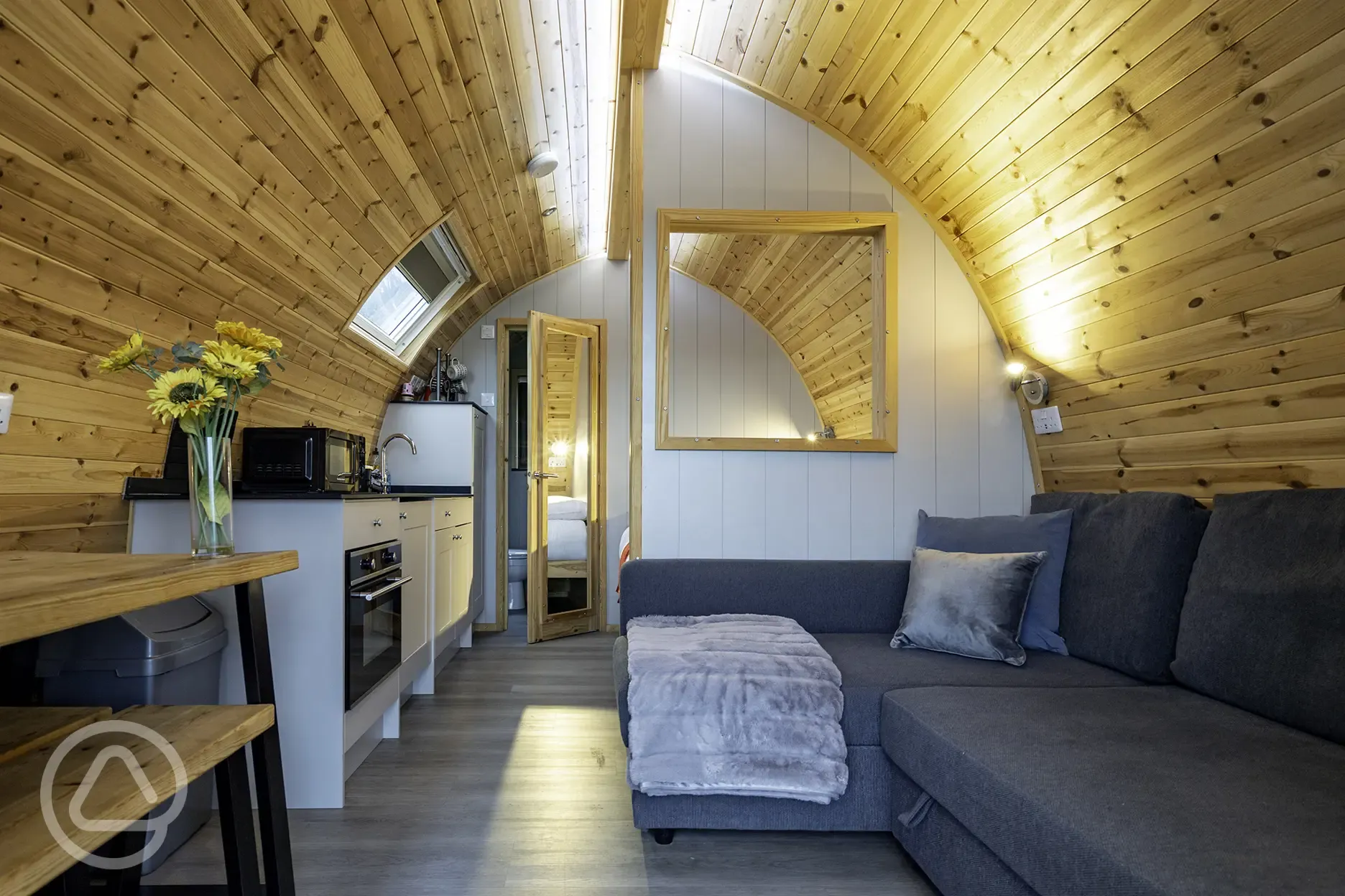 Mega glamping pod interior with a double bed and double sofa bed