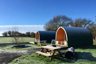 Camping pods with small decking and outdoor furniture