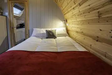 Mega glamping pod interior with a double bed