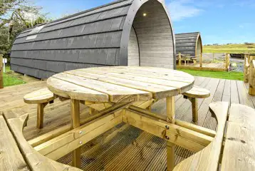 Mega glamping pod with outdoor deck and bench