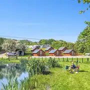 Glamping lodges around the onsite fishing pool (extra cost) at Brook House Farm