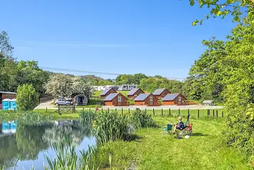 Glamping lodges around the onsite fishing pool (extra cost) at Brook House Farm