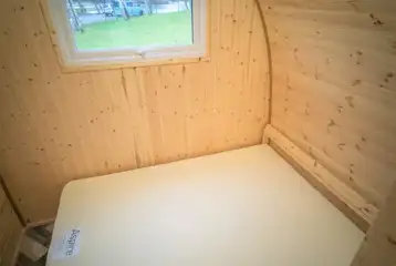 Family camping pod interior with a double bed (bring own bedding)