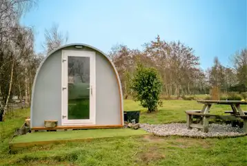 Family camping pods with outdoor picnic benches