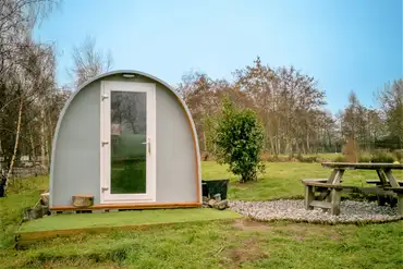 Family camping pods with outdoor picnic benches