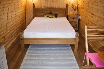 Alder camping pod interior with a double bed (bring own bedding)