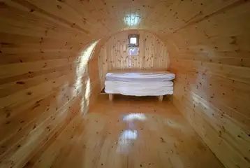 Four person camping pod interior with four single mattresses Four person camping pod interior with four single mattresses