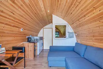 Ensuite Cosier glamping pod sofa bed and kitchen area Ensuite Cosier glamping pod sofa bed and kitchen area