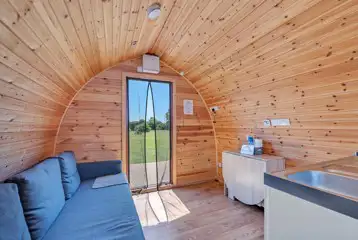 Family glamping pod interior with sofa bed Family glamping pod interior with sofa bed