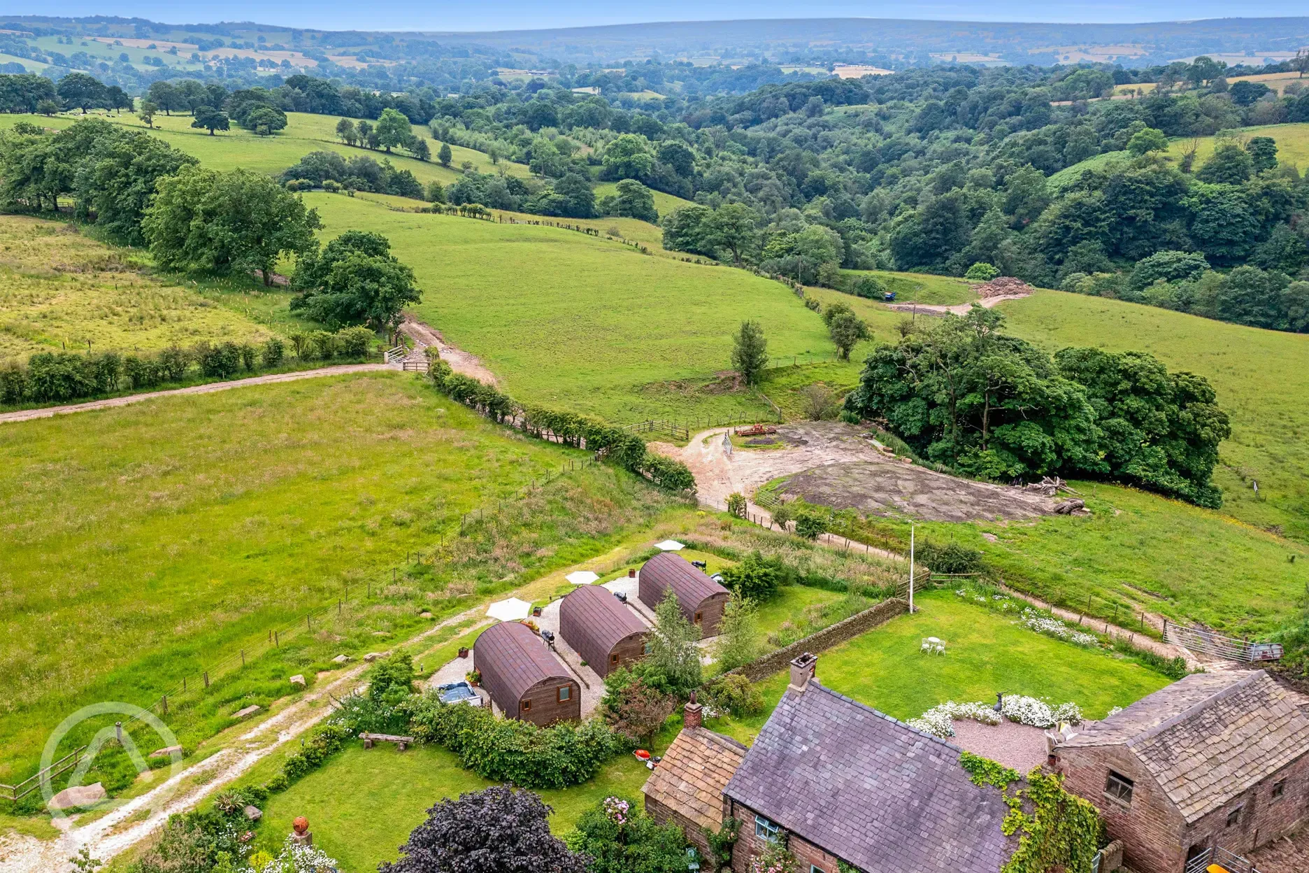 Aerial of the glamping pods with countryside views