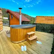 Mini lodge pod with hot tub on private decking area Mini lodge pod with hot tub on private decking area