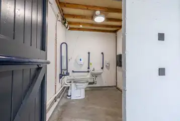 Disabled facilities with handrails, sink and hand dryer Disabled facilities with handrails, sink and hand dryer