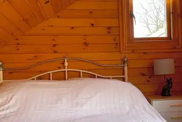 Mini lodge pod interior with double bed Mini lodge pod interior with double bed