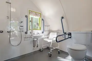 Humbleton accessible wet room with grab rails and a shower chair