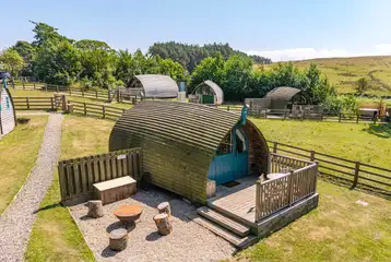 The Wonneys glamping pod with a decking area and fire pit/BBQ grill