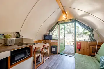 Bare Bones glamping pod kitchen, dining area and smart TV