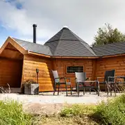 Each glamping cabin has a private outdoor seating area