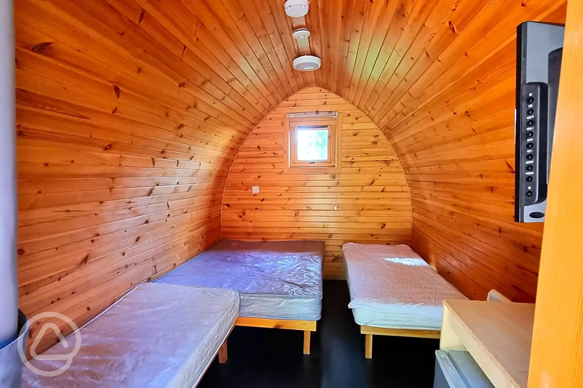 Camping pods with a double bed, twin beds, fridge, kettle and TV