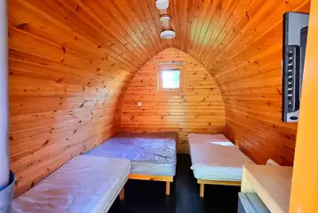 Camping pods with a double bed, twin beds, fridge, kettle and TV