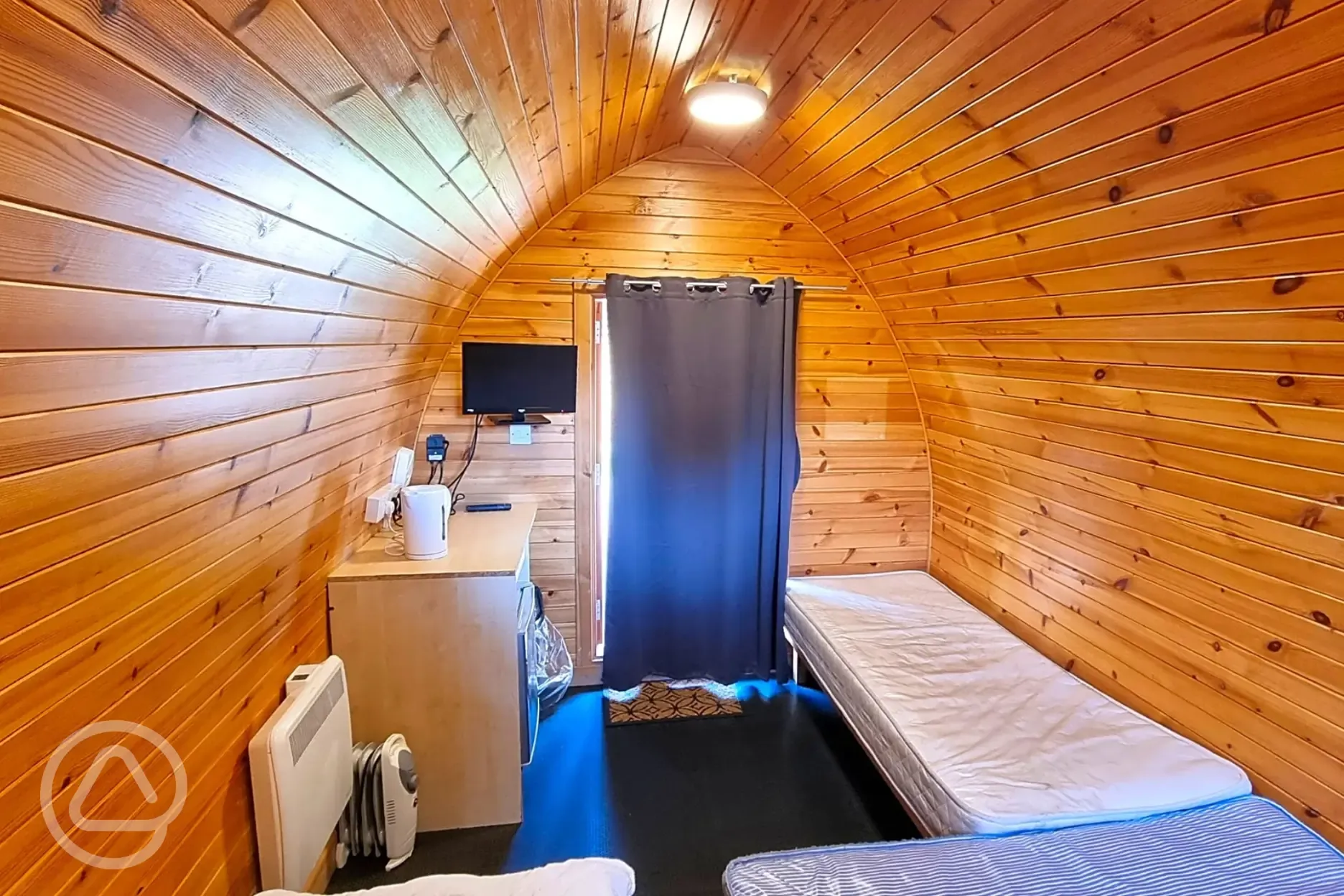 Camping pods with a double bed, twin beds, fridge, kettle, heating and TV