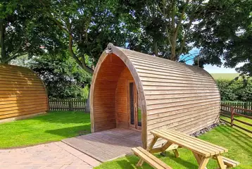 Camping pod with a private outdoor picnic bench