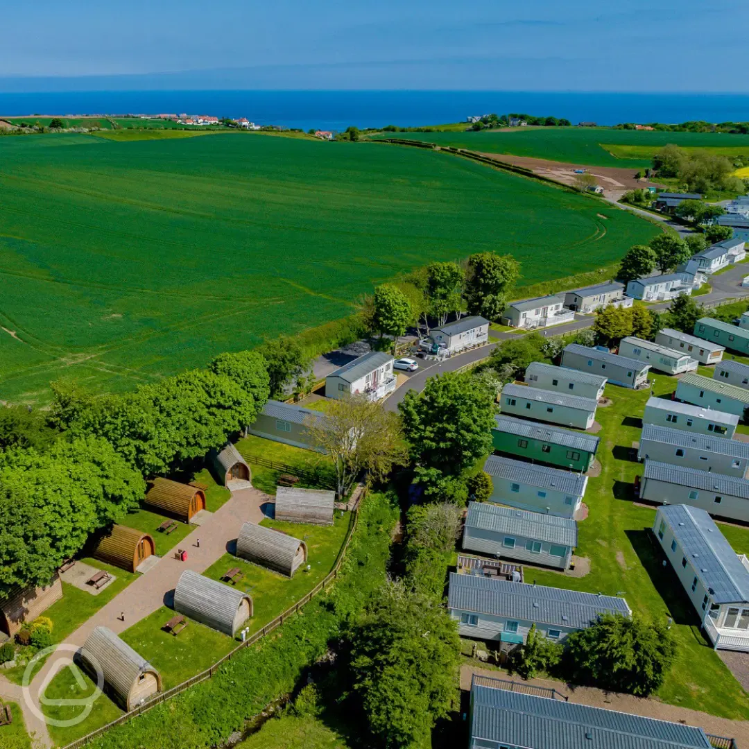 Aerial of Scoutscroft Leisure Park with the camping pods and coastal views