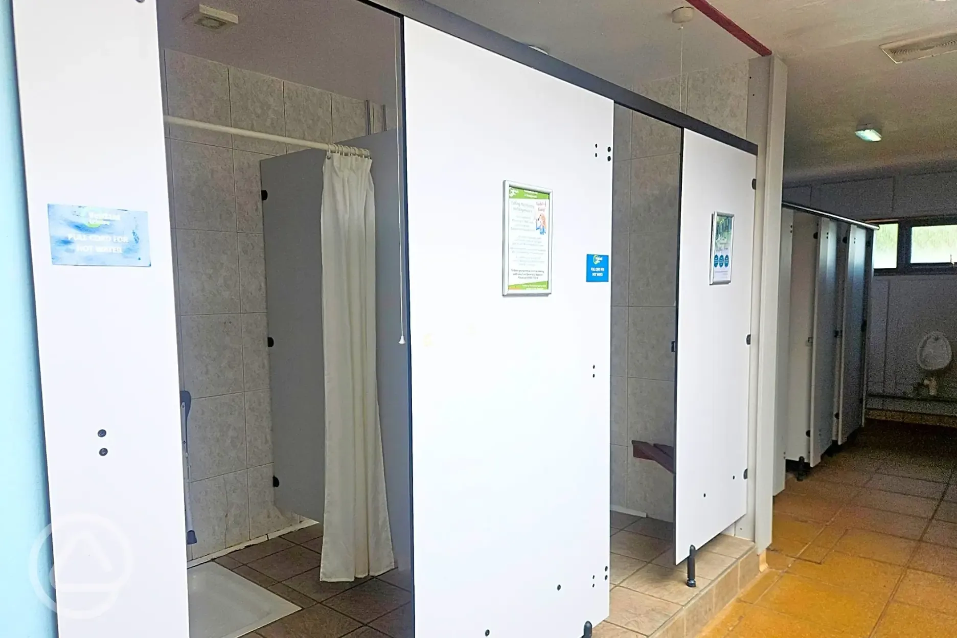 Shower cubicles with room to change and a small bench